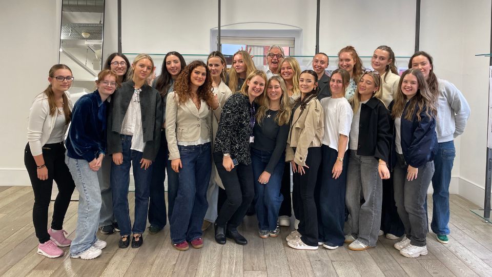 Creative Arts students posing for a photo with Paul Smith